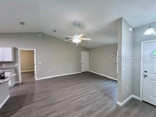 20193 Southwest 83rd Street Dunnellon, FL 34431 - Photo 8 of 31 an empty room with wooden floor and a ceiling fan