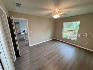 20193 Southwest 83rd Street Dunnellon, FL 34431 - Photo 10 of 31 an empty room with wooden floor and windows