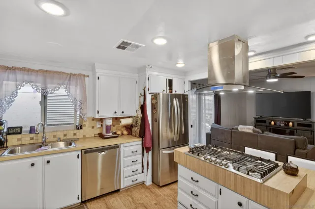 a kitchen with refrigerator and stove