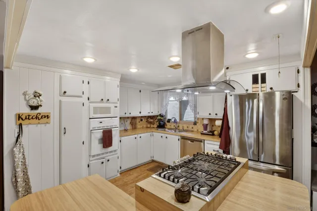 a kitchen with a refrigerator and a stove