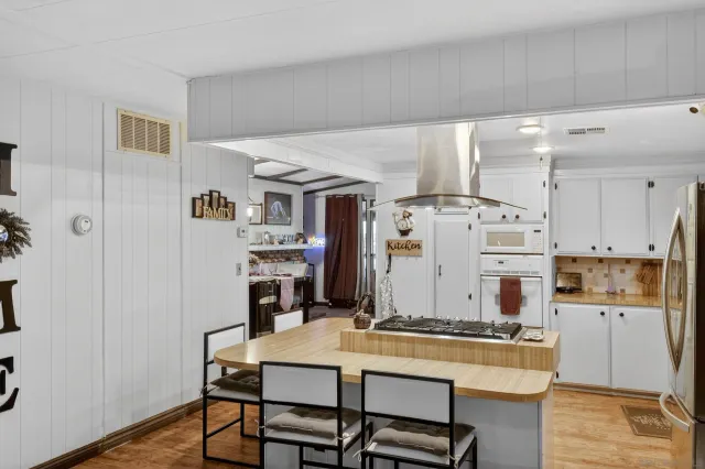 a view of a kitchen with dining table and chairs