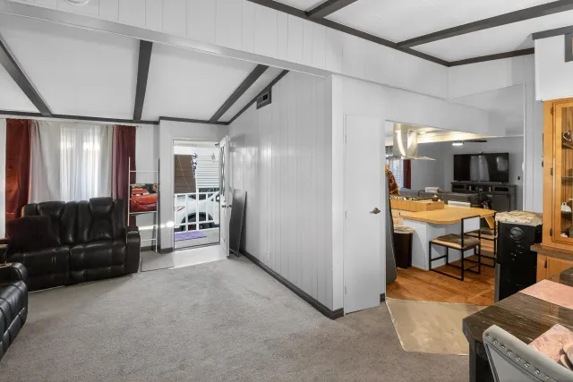 a view of living room kitchen with furniture and flat screen tv