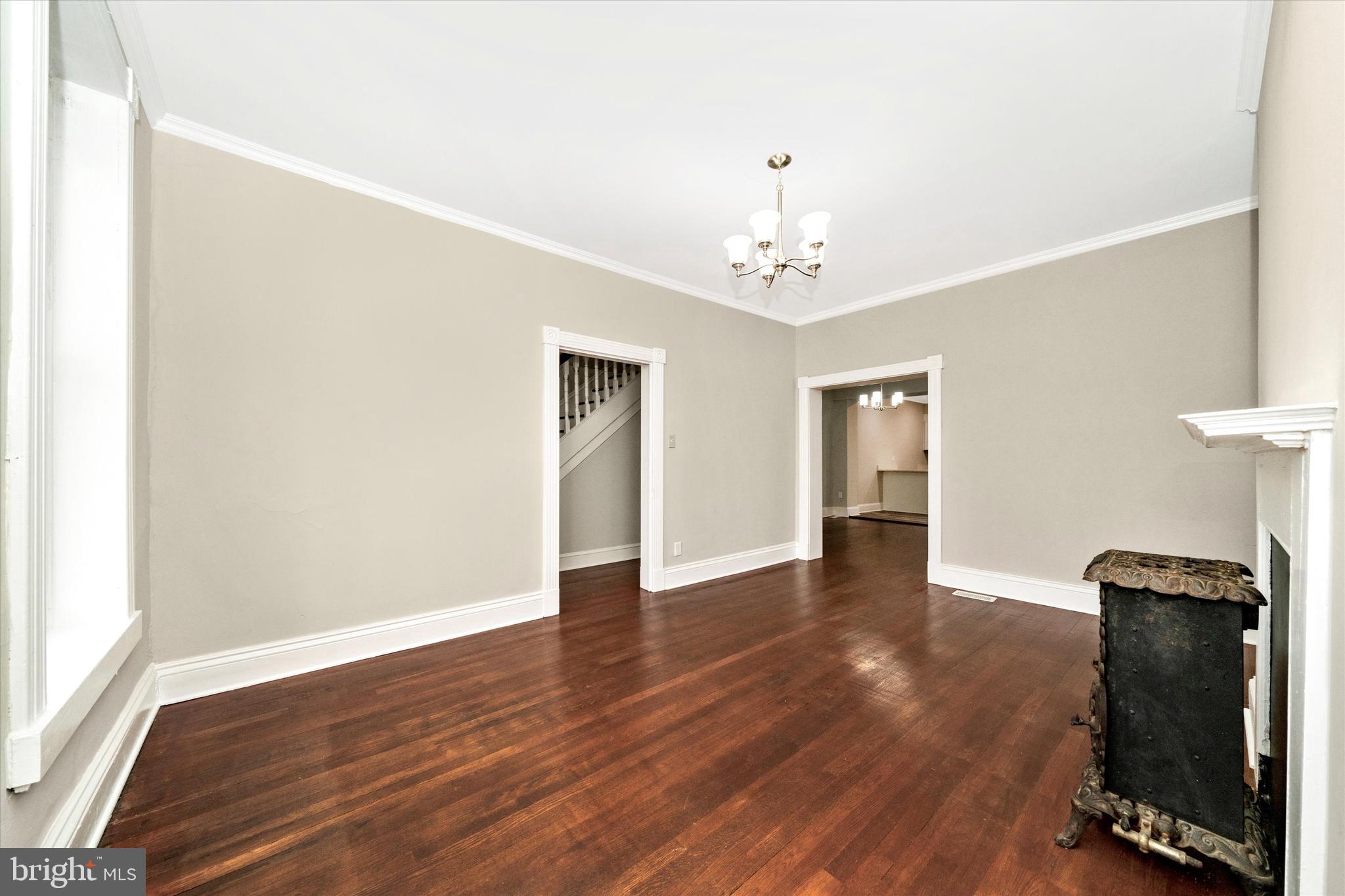 129 West 4th Street Frederick, MD 21701 - Photo 11 of 70 a view of an empty room with wooden floor and a window
