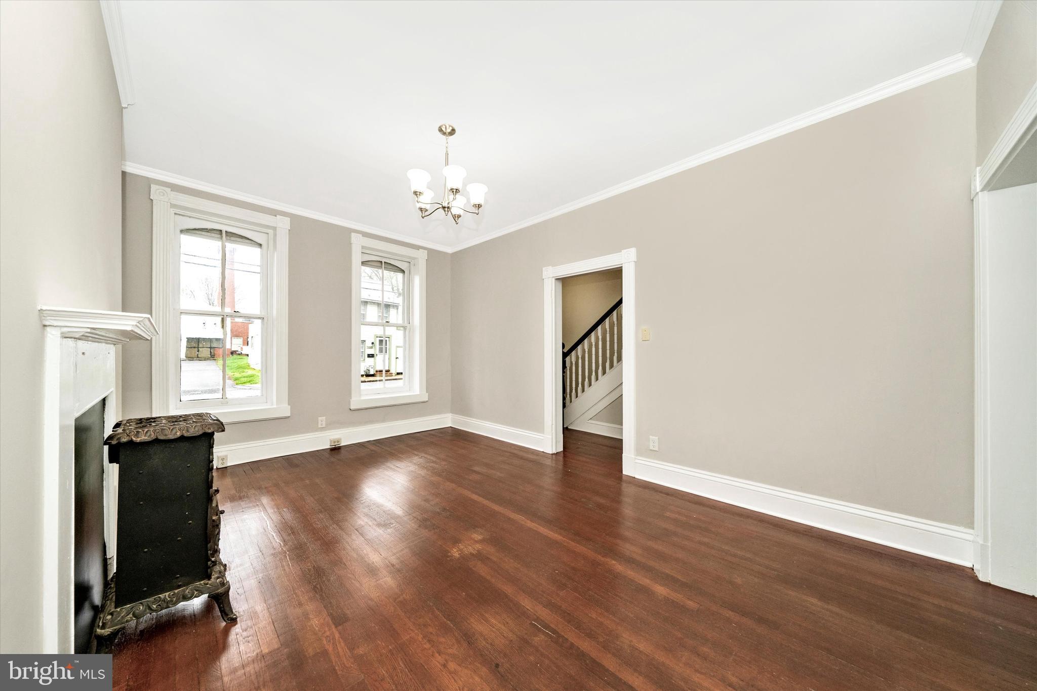 129 West 4th Street Frederick, MD 21701 - Photo 12 of 70 an empty room with wooden floor and windows