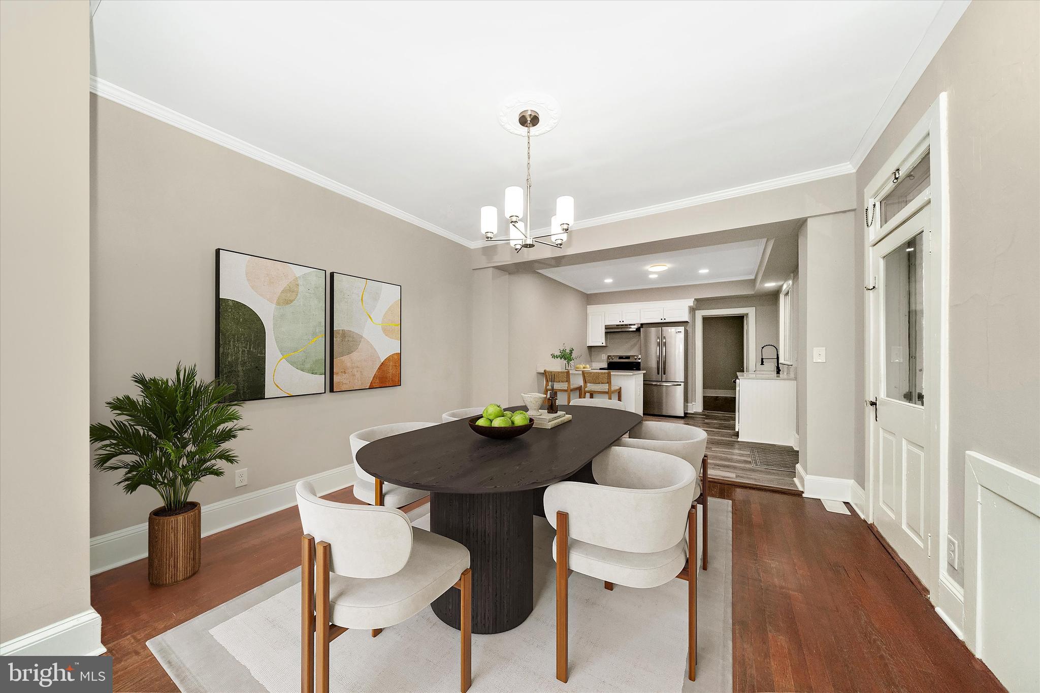 129 West 4th Street Frederick, MD 21701 - Photo 13 of 70 a dining room with wooden floor a chandelier a glass table and chairs