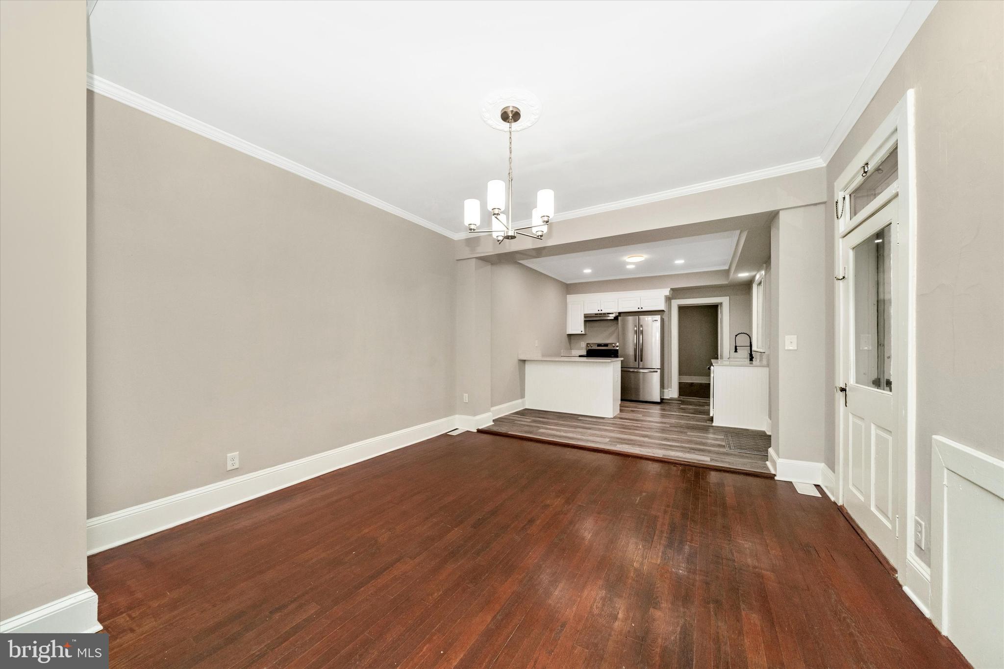129 West 4th Street Frederick, MD 21701 - Photo 14 of 70 a view of a hallway with wooden floor and a chandelier