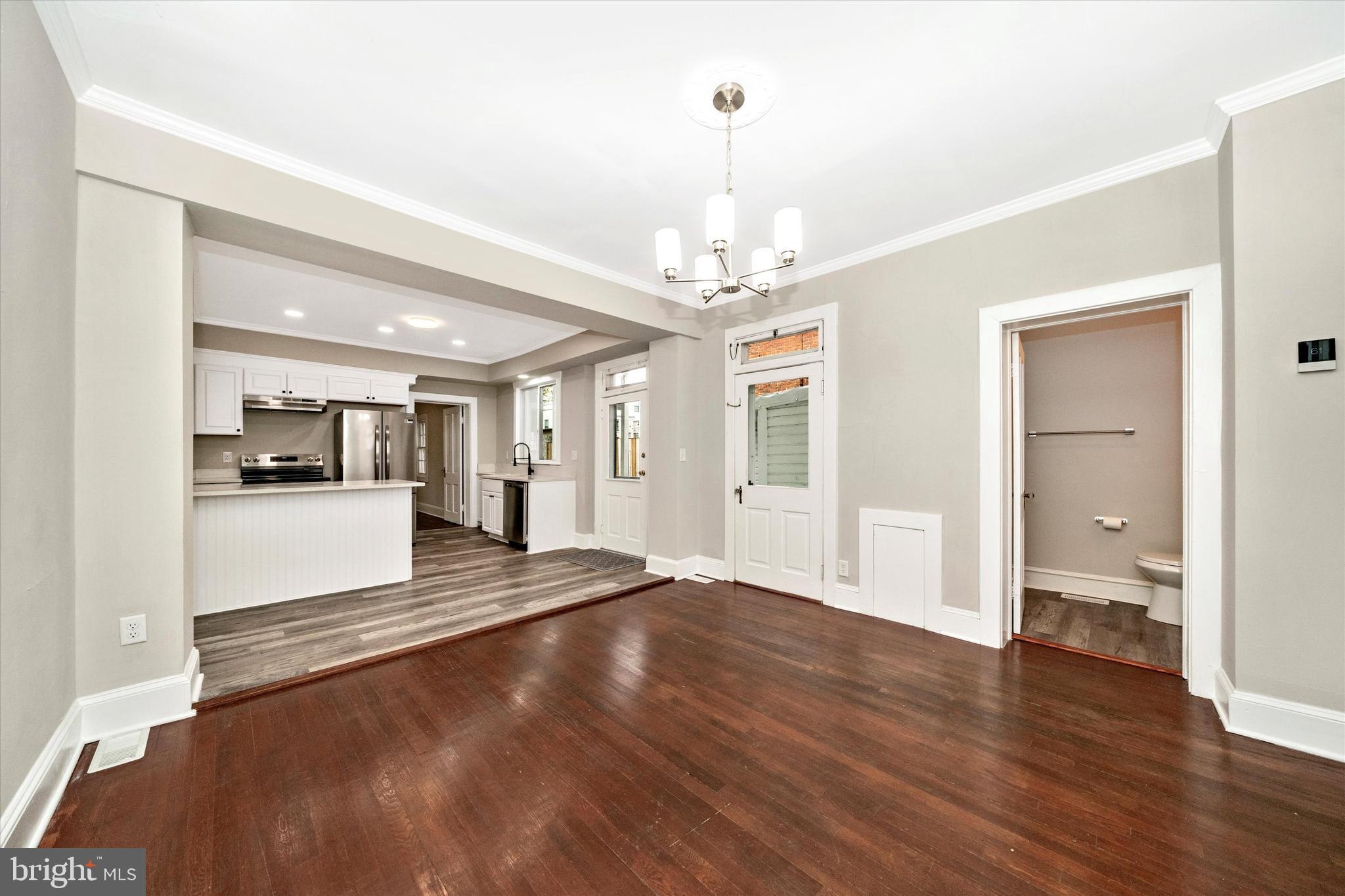 129 West 4th Street Frederick, MD 21701 - Photo 15 of 70 a view of a livingroom with wooden floor and kitchen