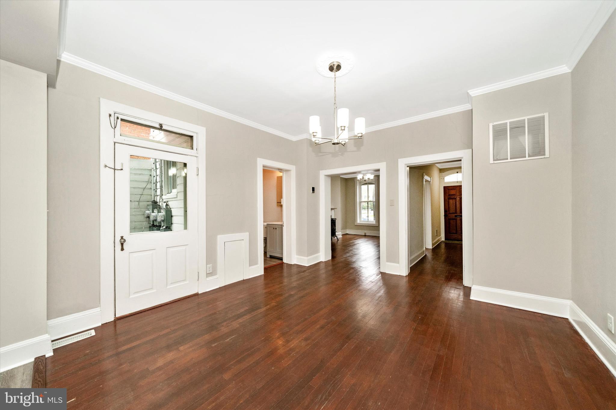 129 West 4th Street Frederick, MD 21701 - Photo 16 of 70 a view of a hallway with wooden floor and chandelier