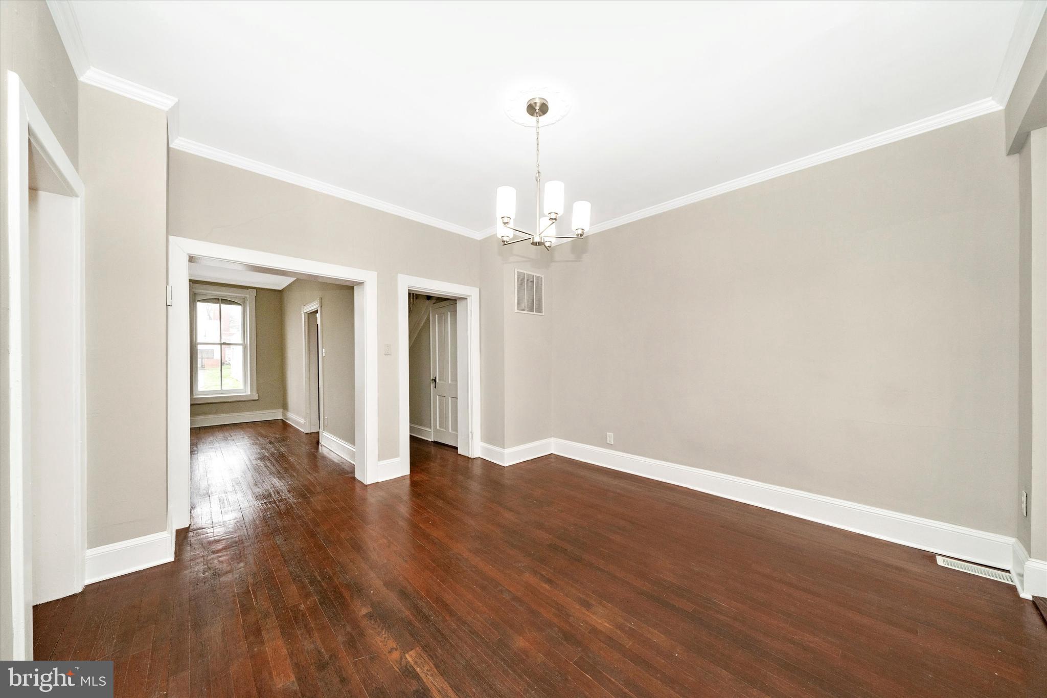 129 West 4th Street Frederick, MD 21701 - Photo 17 of 70 an empty room with wooden floor and windows