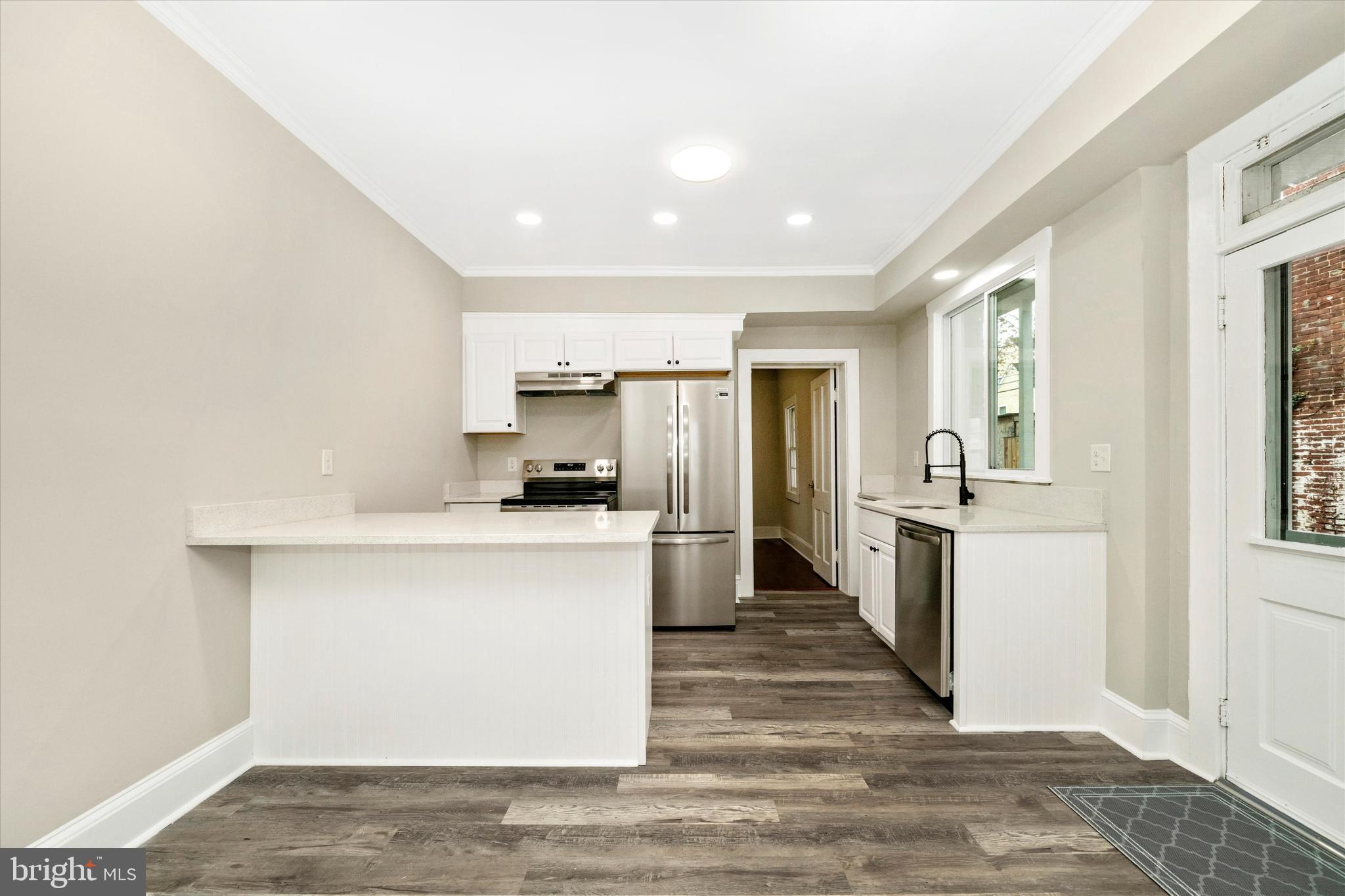 129 West 4th Street Frederick, MD 21701 - Photo 18 of 70 a kitchen with a refrigerator and a sink