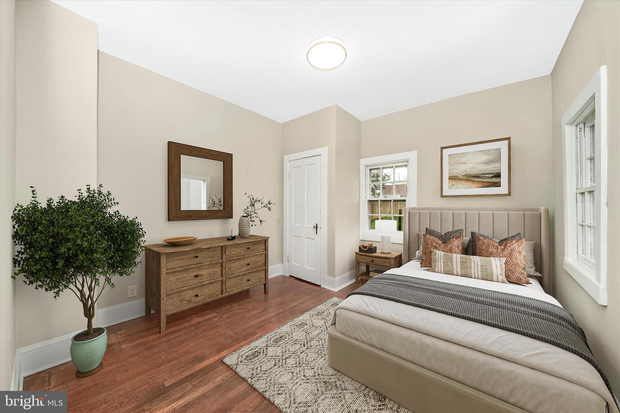 129 West 4th Street Frederick, MD 21701 - Photo 24 of 70 a bedroom with a bed and a potted plant