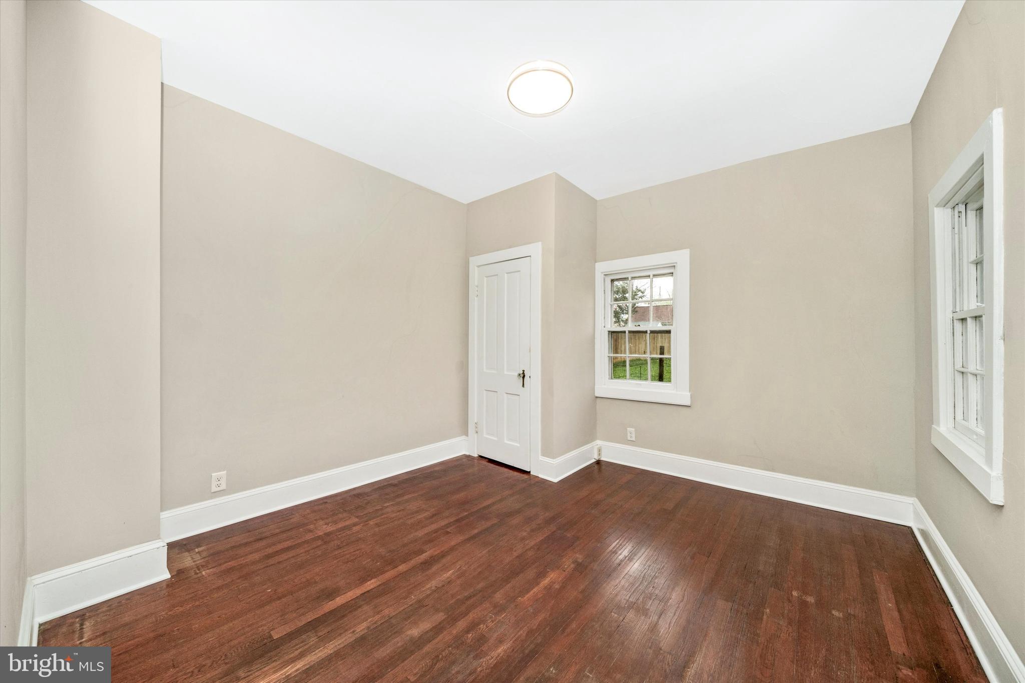 129 West 4th Street Frederick, MD 21701 - Photo 25 of 70 an empty room with wooden floor and windows
