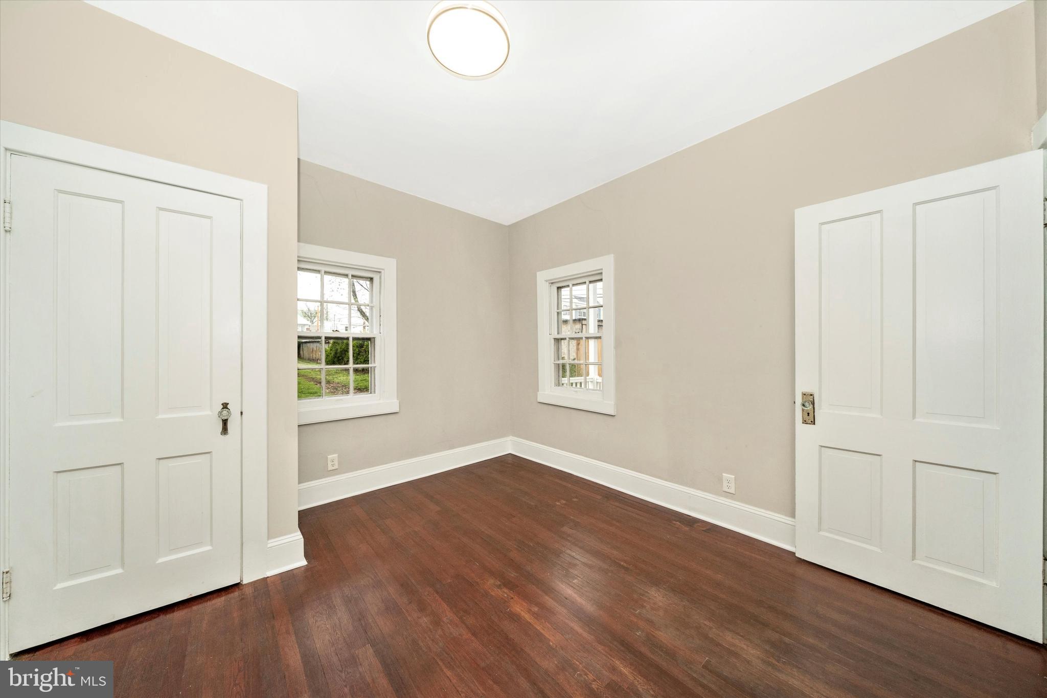 129 West 4th Street Frederick, MD 21701 - Photo 26 of 70 an empty room with wooden floor and windows