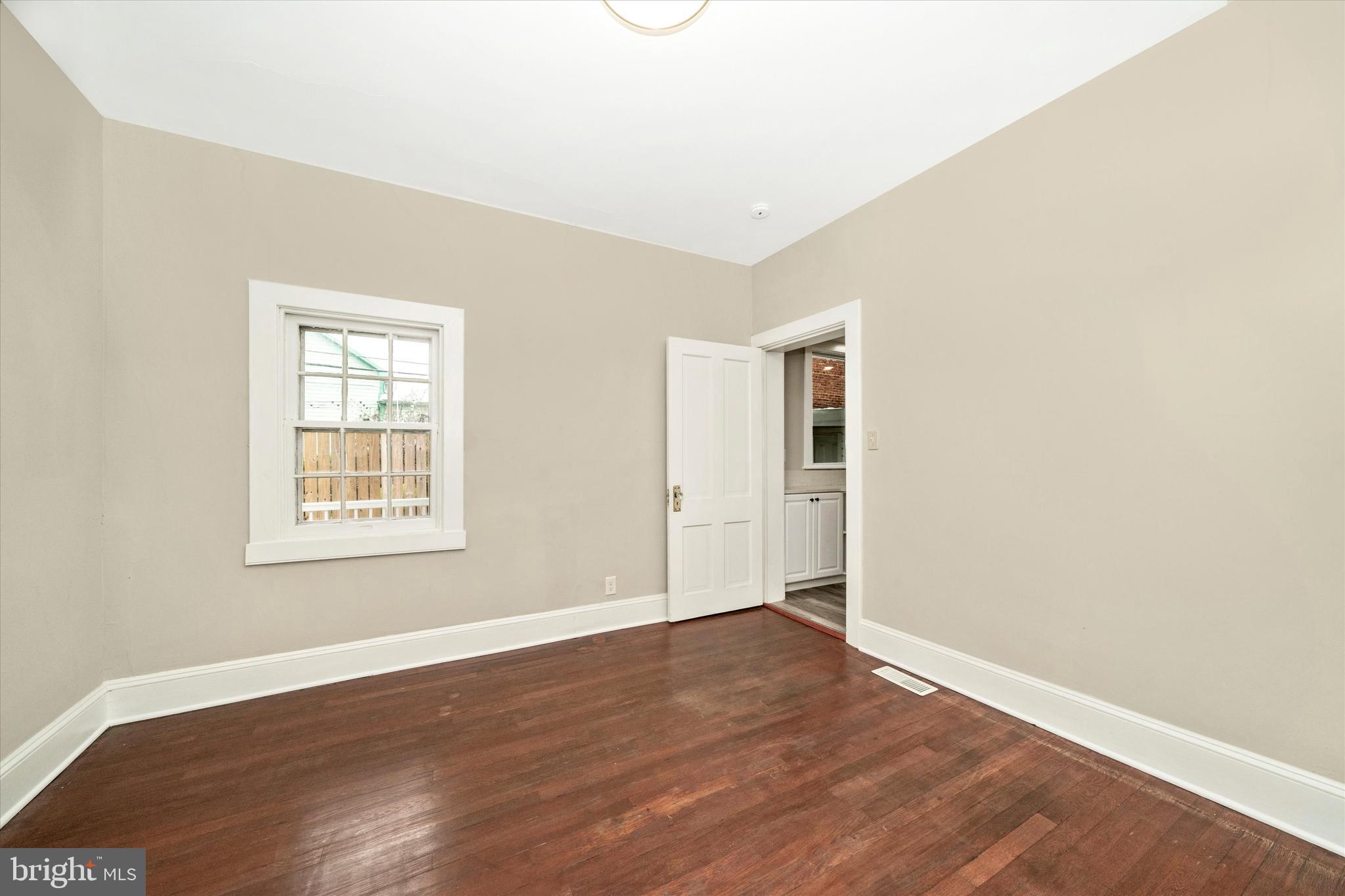 129 West 4th Street Frederick, MD 21701 - Photo 27 of 70 an empty room with wooden floor and windows
