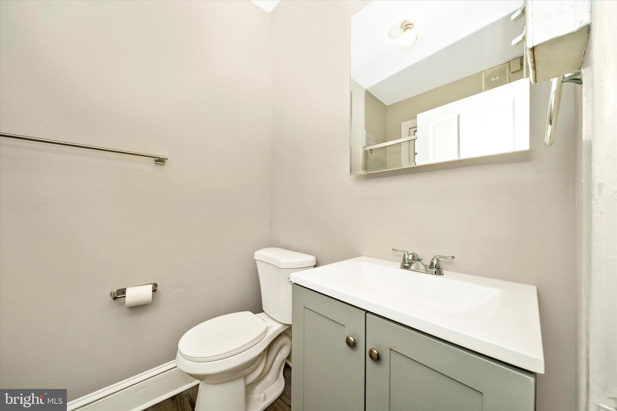 129 West 4th Street Frederick, MD 21701 - Photo 29 of 70 a bathroom with a sink mirror and toilet