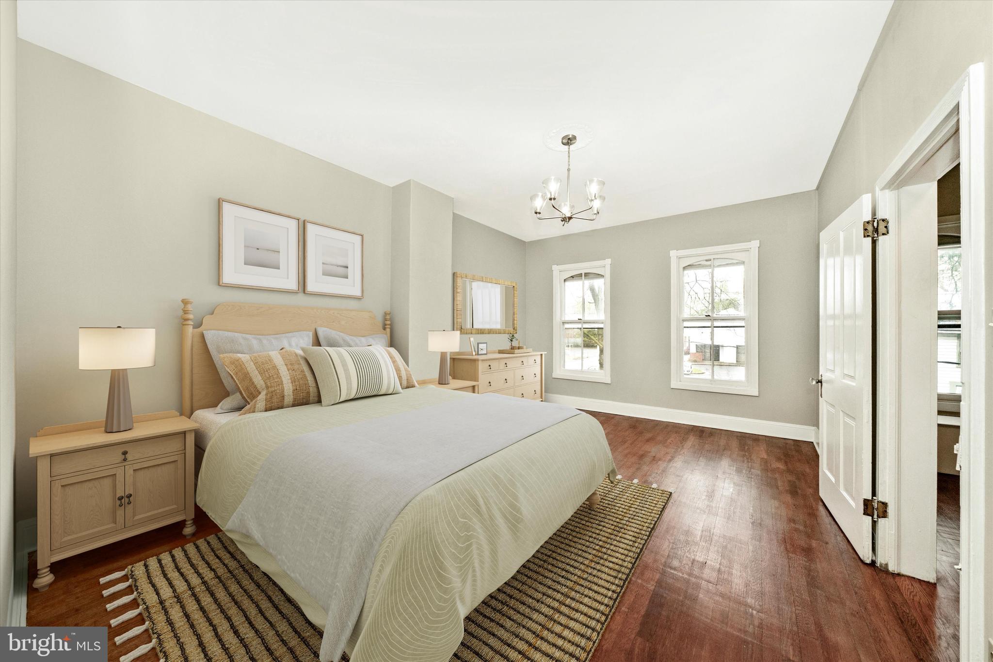 129 West 4th Street Frederick, MD 21701 - Photo 36 of 70 a spacious bedroom with a bed and wooden floor