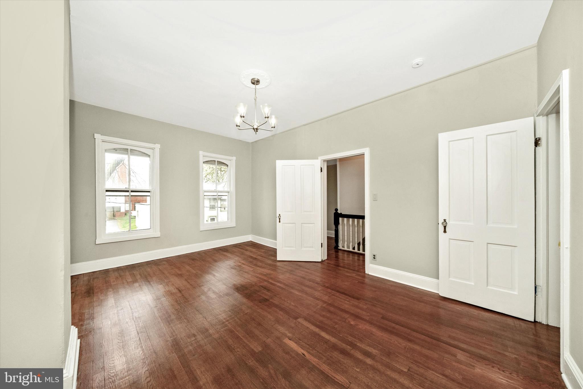 129 West 4th Street Frederick, MD 21701 - Photo 38 of 70 a view of an empty room with wooden floor and a window