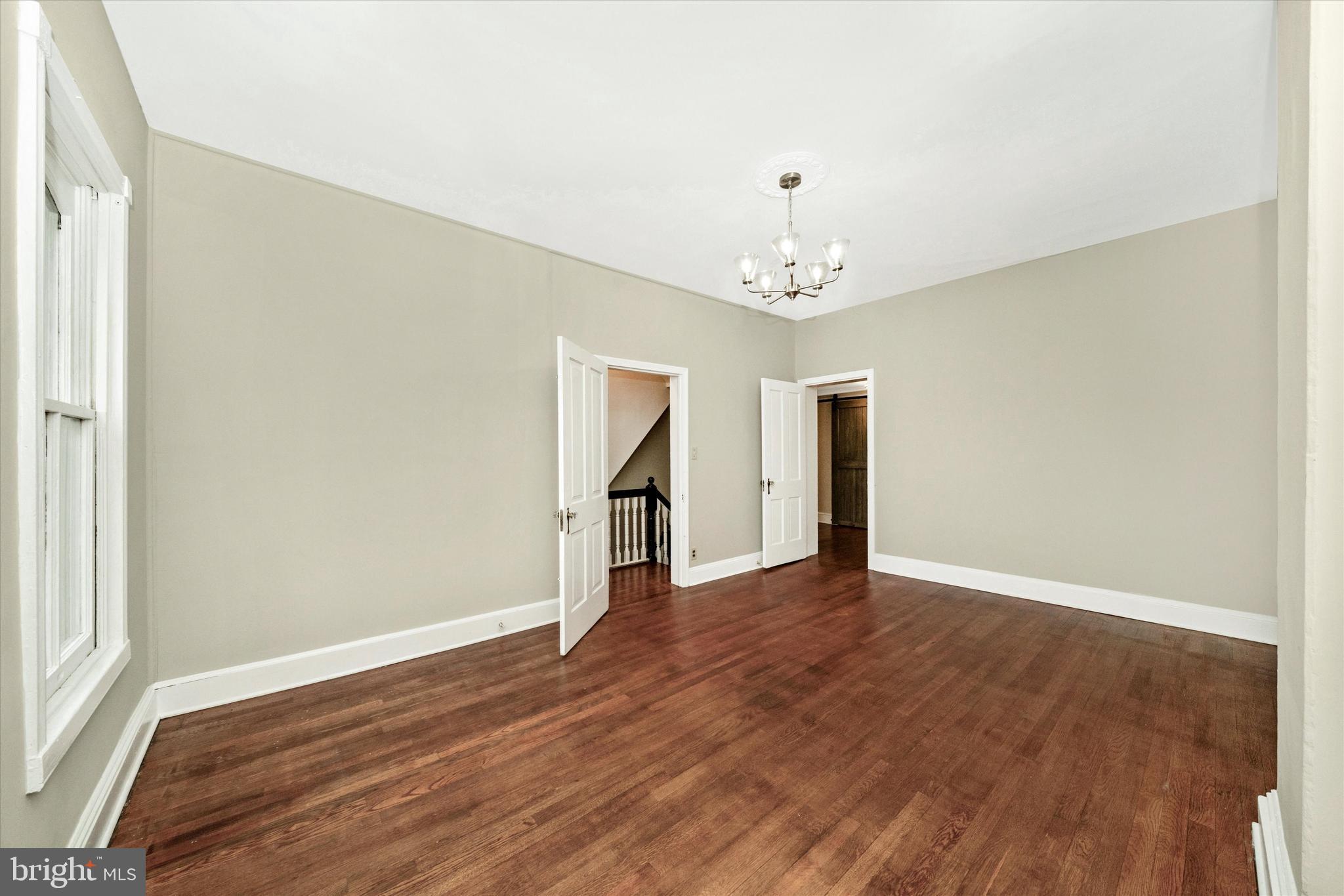 129 West 4th Street Frederick, MD 21701 - Photo 39 of 70 a view of an empty room with wooden floor