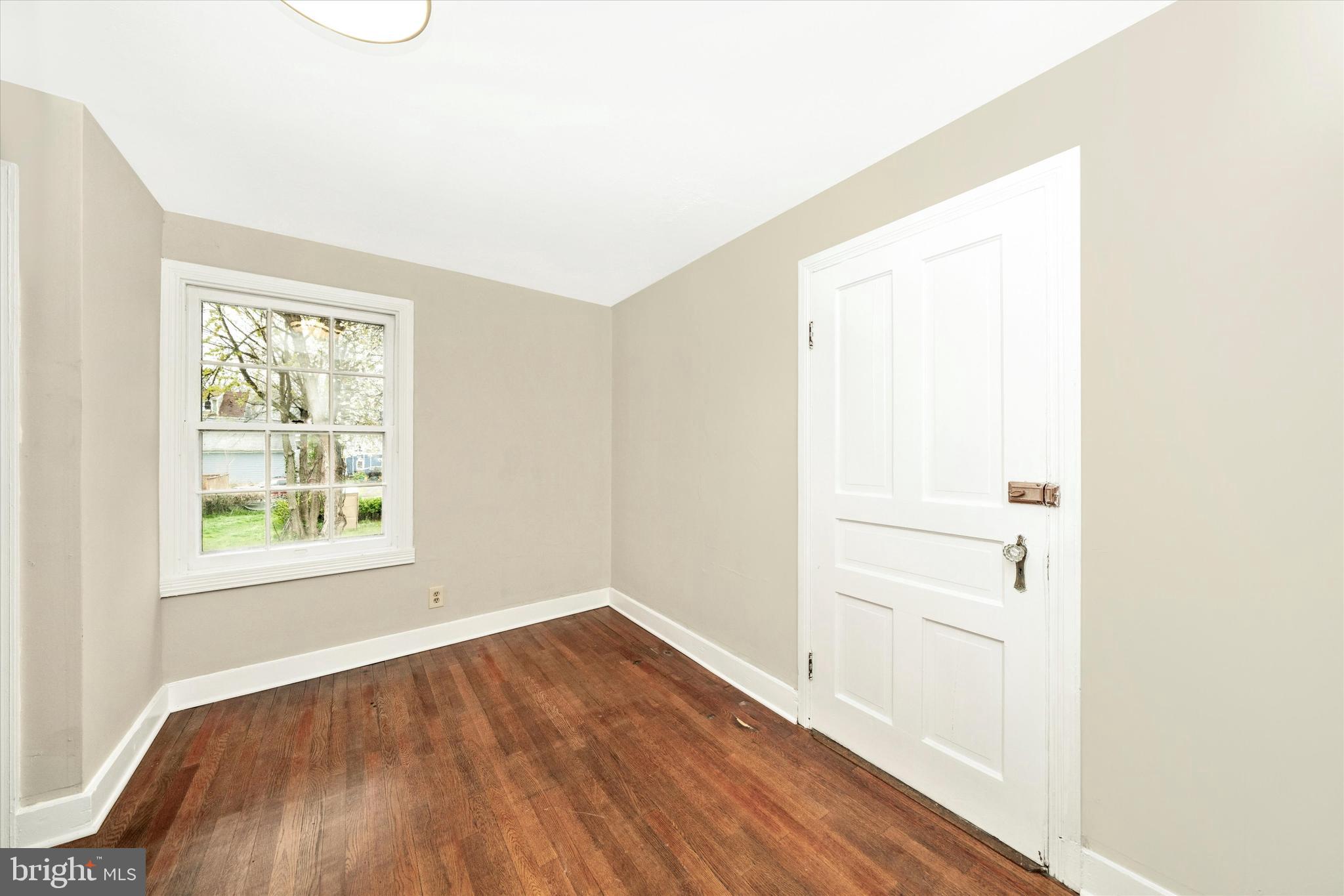 129 West 4th Street Frederick, MD 21701 - Photo 44 of 70 an empty room with wooden floor and windows