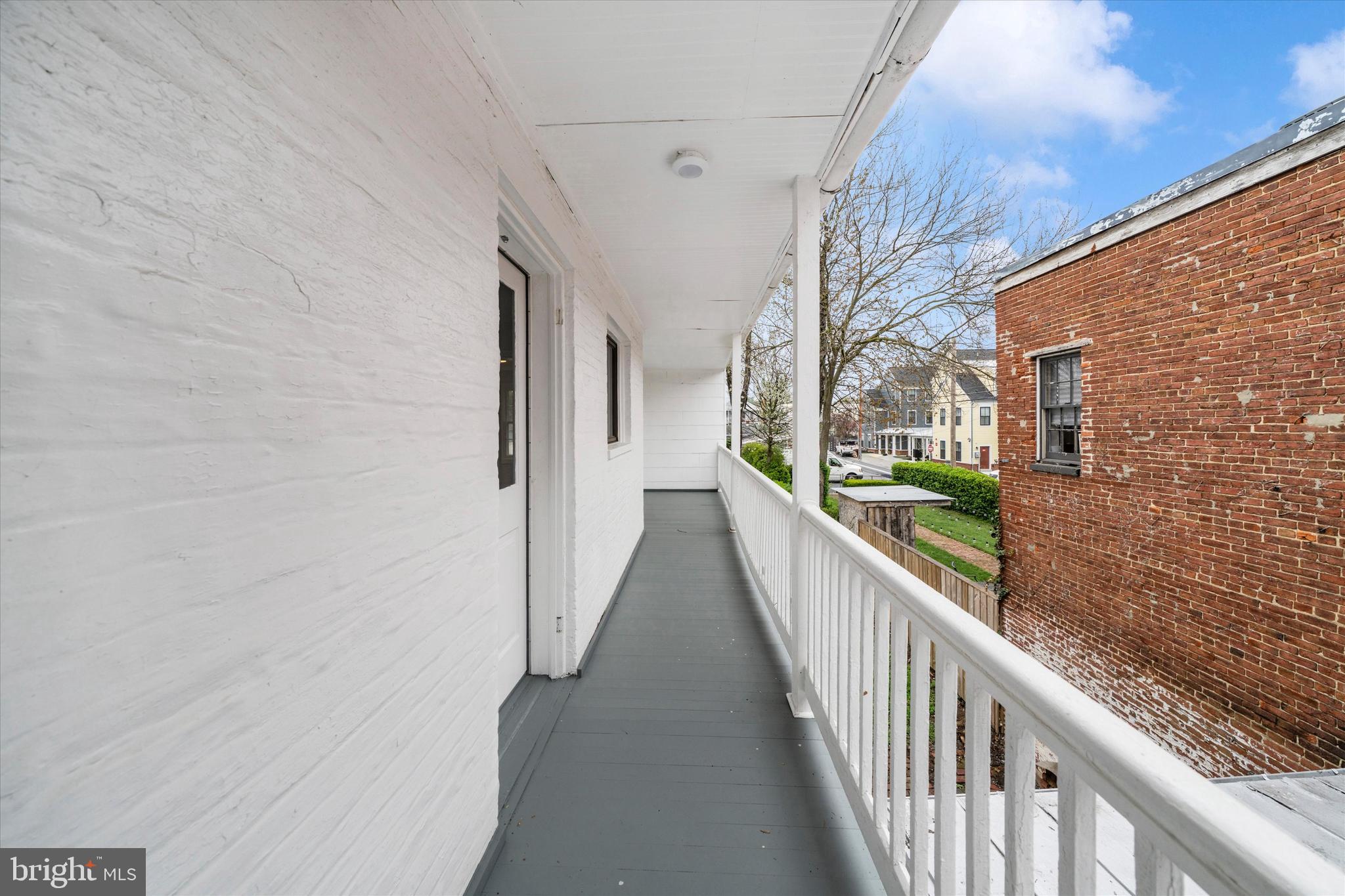 129 West 4th Street Frederick, MD 21701 - Photo 53 of 70 a view of a balcony with wooden floor and stairs