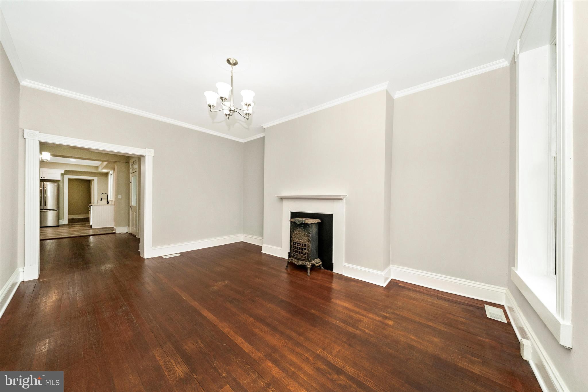 129 West 4th Street Frederick, MD 21701 - Photo 10 of 70 a view of a livingroom with wooden floor and a fireplace