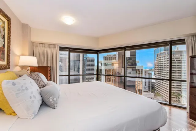 a bedroom with a large bed and a large window