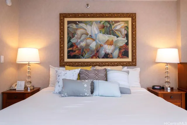 a bedroom with a bed and a lamp on table