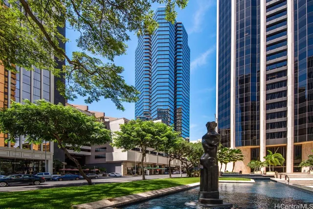 a front view of a building with trees