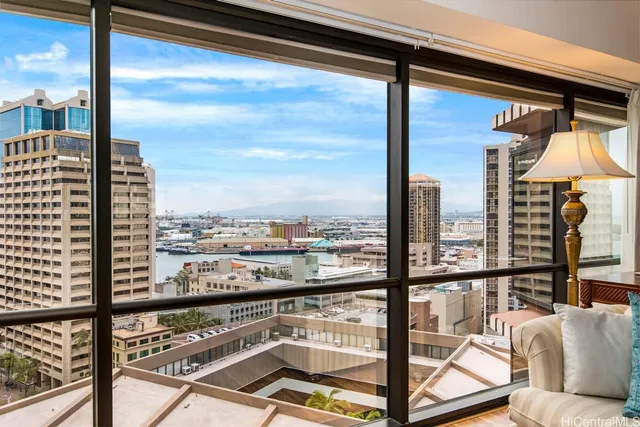 a view of a balcony with couches and wooden floor