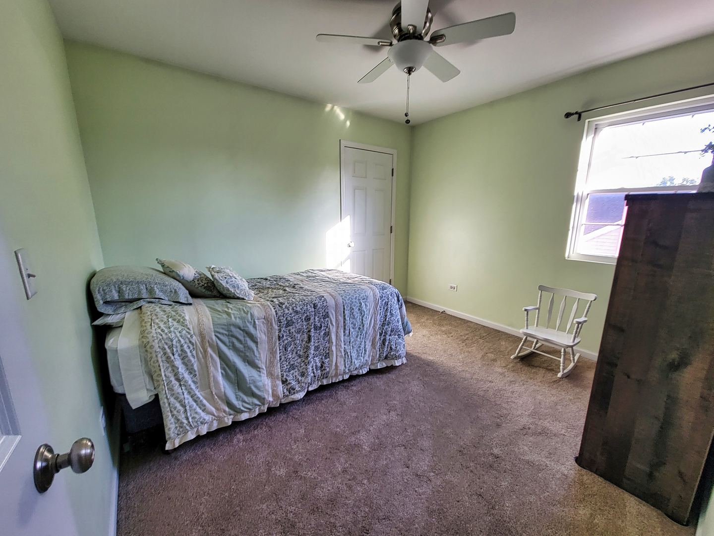 292 South Will Road Diamond, IL 60416 - Photo 13 of 19 a spacious bedroom with a bed and a chandelier