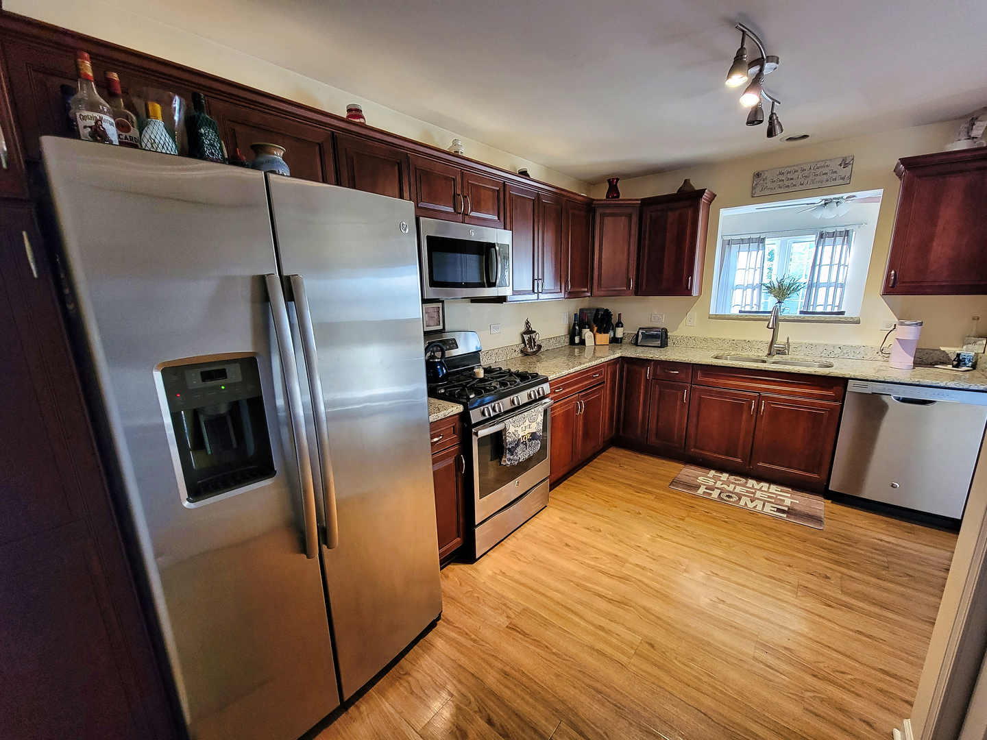292 South Will Road Diamond, IL 60416 - Photo 5 of 19 a kitchen with stainless steel appliances granite countertop a refrigerator a sink a stove a washer dryer and a refrigerator