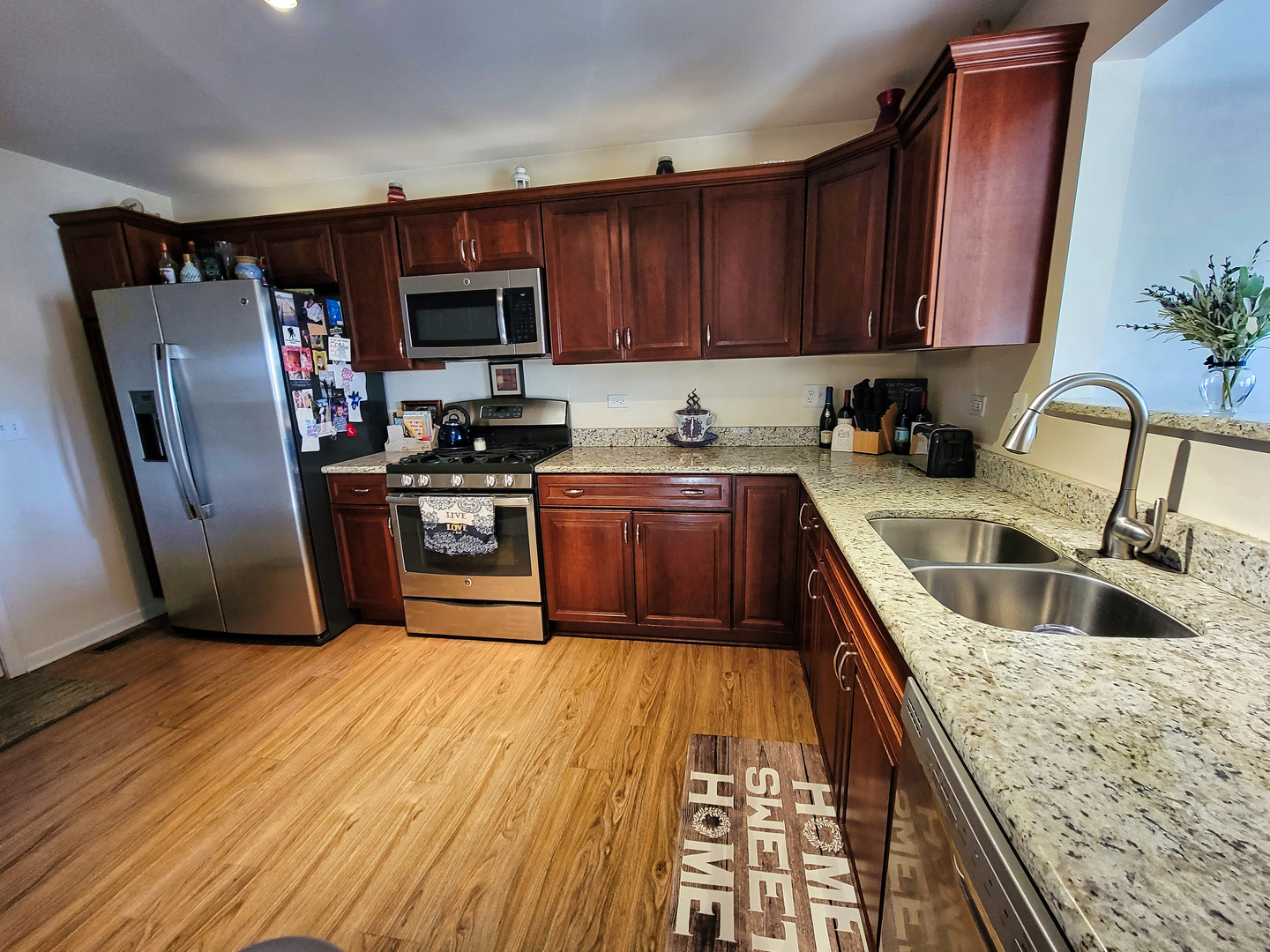292 South Will Road Diamond, IL 60416 - Photo 6 of 19 a kitchen with a sink a refrigerator and cabinets