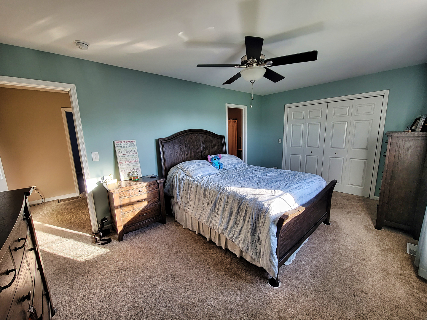 292 South Will Road Diamond, IL 60416 - Photo 10 of 19 a bedroom with a bed flat screen tv and a chandelier