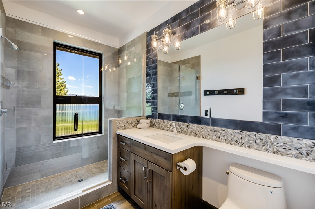 567 Alden Lane Incline Village, NV 89451 - Photo 18 of 35 a bathroom with a granite countertop sink and a mirror