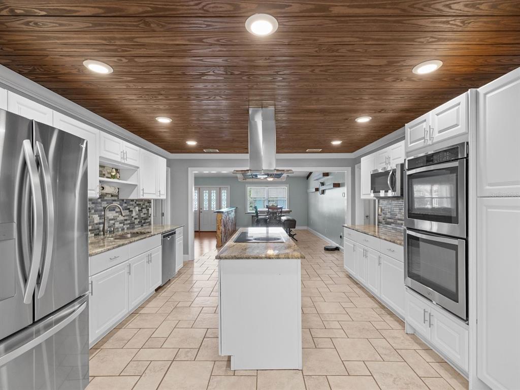 5904 Springrun Court Holiday, FL 34690 - Photo 20 of 53 a kitchen with stainless steel appliances granite countertop a refrigerator and a stove