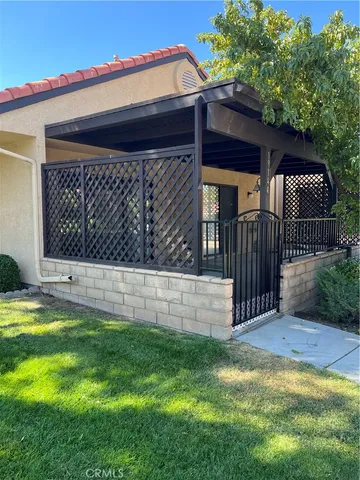 a view of backyard with wooden fence and large trees