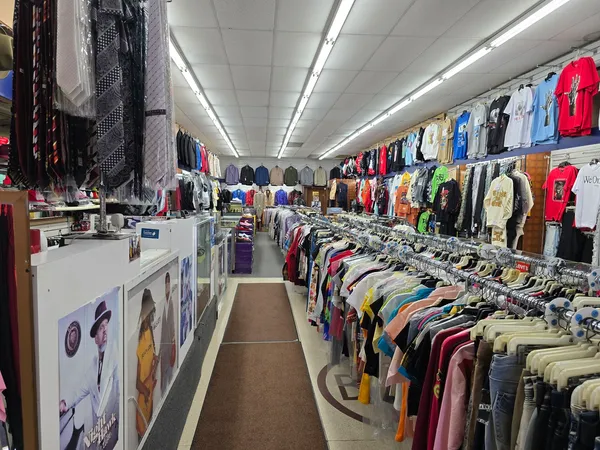 a view of walk in closet with clothes and shoes