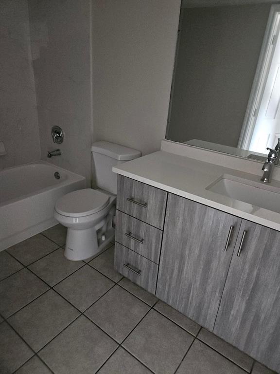 5041 Wiles Road, Unit 201 Coconut Creek, FL 33073 - Photo 11 of 17 a bathroom with a toilet a sink and bathtub