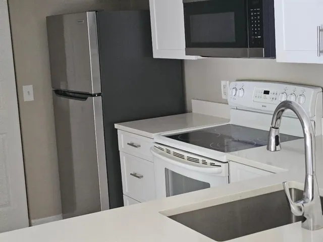 a view of an empty room with a floor to ceiling window and an empty room