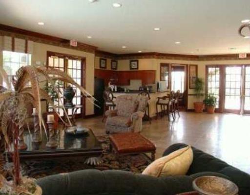 5041 Wiles Road, Unit 201 Coconut Creek, FL 33073 - Photo 3 of 17 a living room with furniture window and wooden floor