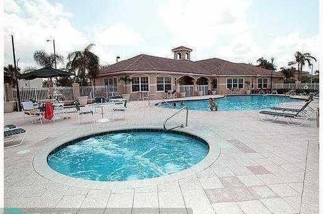 5041 Wiles Road, Unit 201 Coconut Creek, FL 33073 - Photo 6 of 17 a view of a house with pool