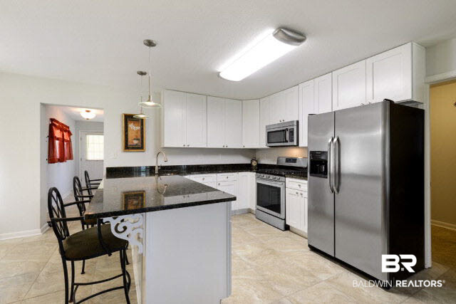 1903 Juniper Street North Foley, AL 36535 - Photo 3 of 16 New natural gas ss stove & ss refrigerator. Granite countertops, all new cabinets.