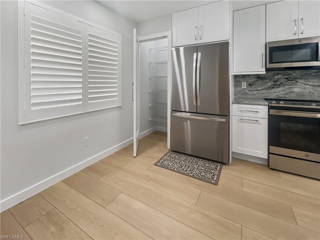 5908 Cranbrook Way, Unit I202 Naples, FL 34112 - Photo 7 of 45 a kitchen with a refrigerator a stove and cabinets