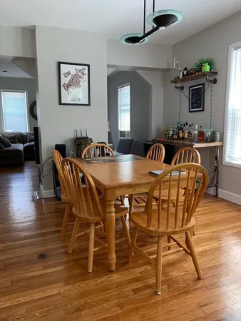a view of a dining room with furniture wooden floor and chandelier