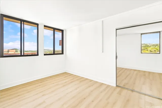 a roof deck with couches and potted plants