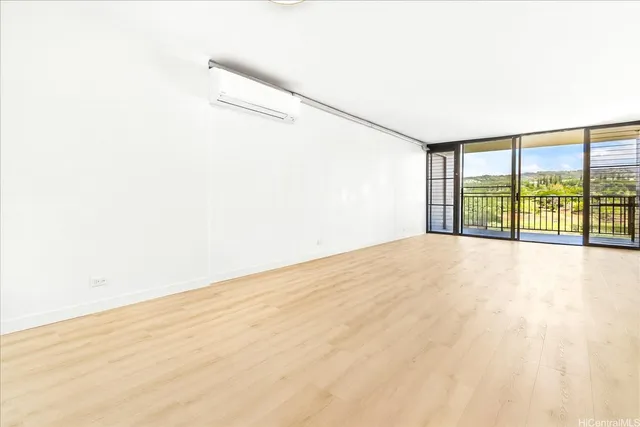 a view of a bedroom with wooden floor and natural light