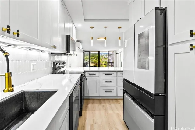 a view of a living room with furniture and wooden floor