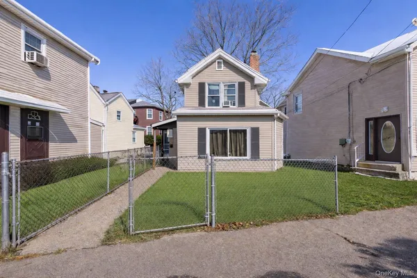 a front view of a house with a garden and yard