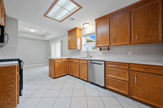 a kitchen with stainless steel appliances granite countertop a sink stove and cabinets