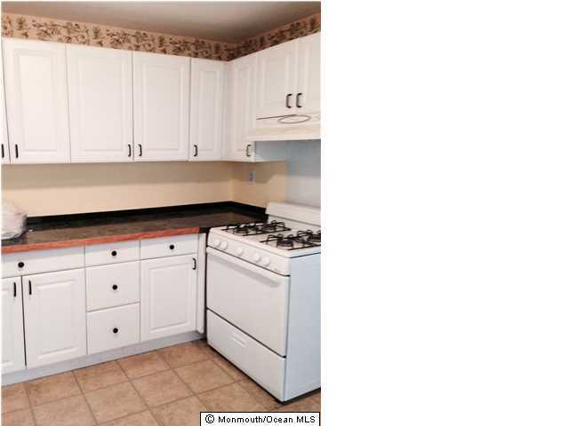 42 Washington Street Red Bank, NJ 07701 - Photo 4 of 6 a kitchen with white cabinets and white appliances
